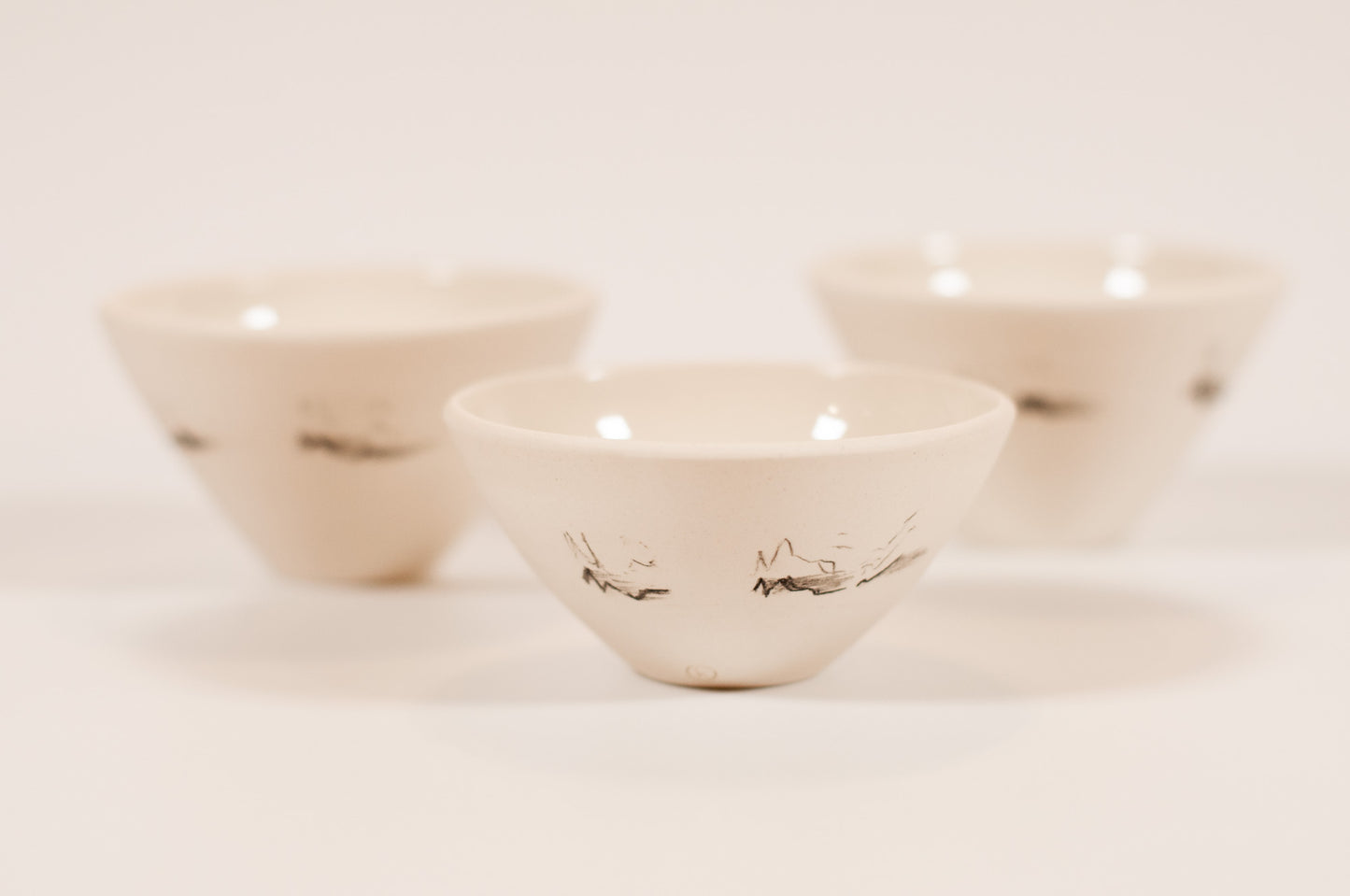 Handmade small porcelain bowl, fits comfortably in the hand, glazed interior, polished exterior, Canadian-made, Echo Collection, bird soundwave design